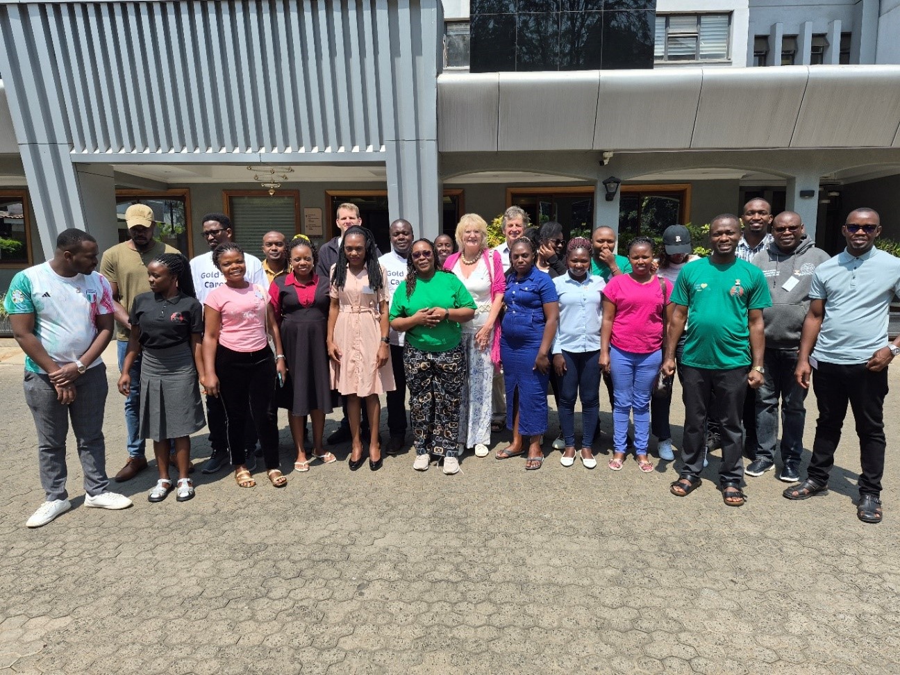 A group photo of both teams on the final day of the Gold Care Symposium