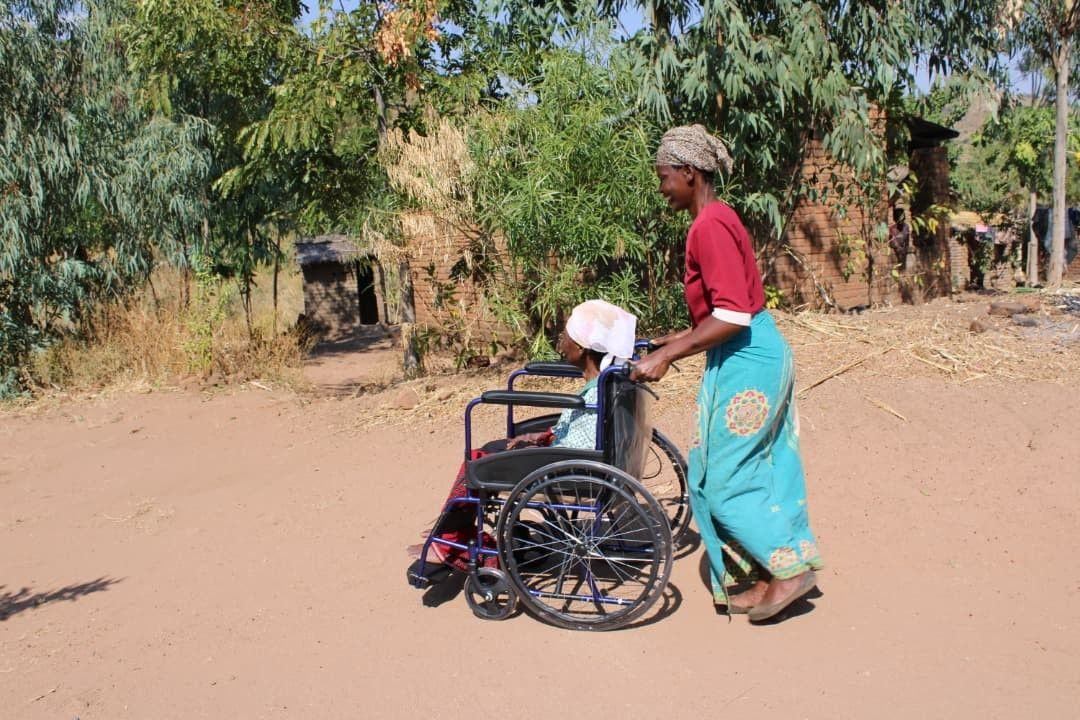 A donated wheelchair helps a daughter take her mother outdoors.