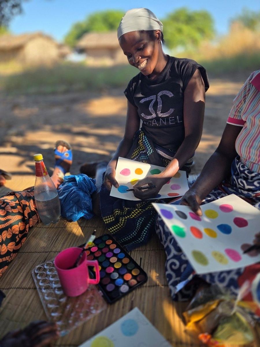 A mother and daughter paint together during a weekly home visit.