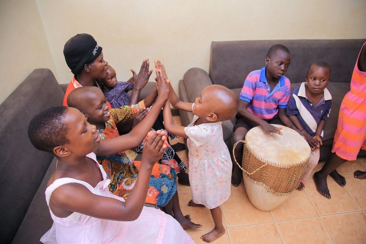 Children play and sing together at New Hope Children's Hostel during cancer treatment.
