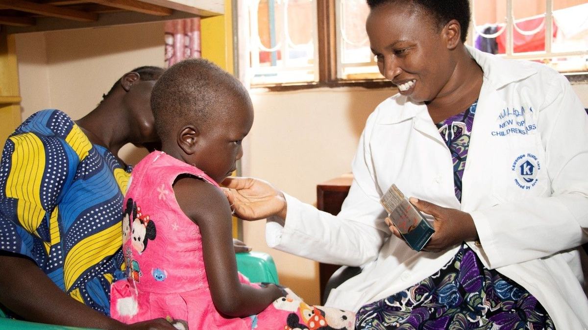 A nurse explains a child's medicines to a parent at New Hope Children's Hostel.