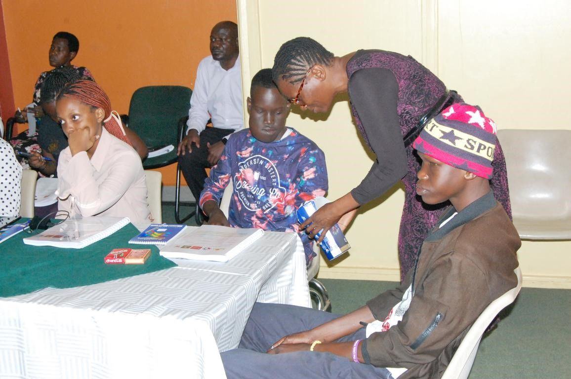 A community meeting brings people together to offer support to a young man.